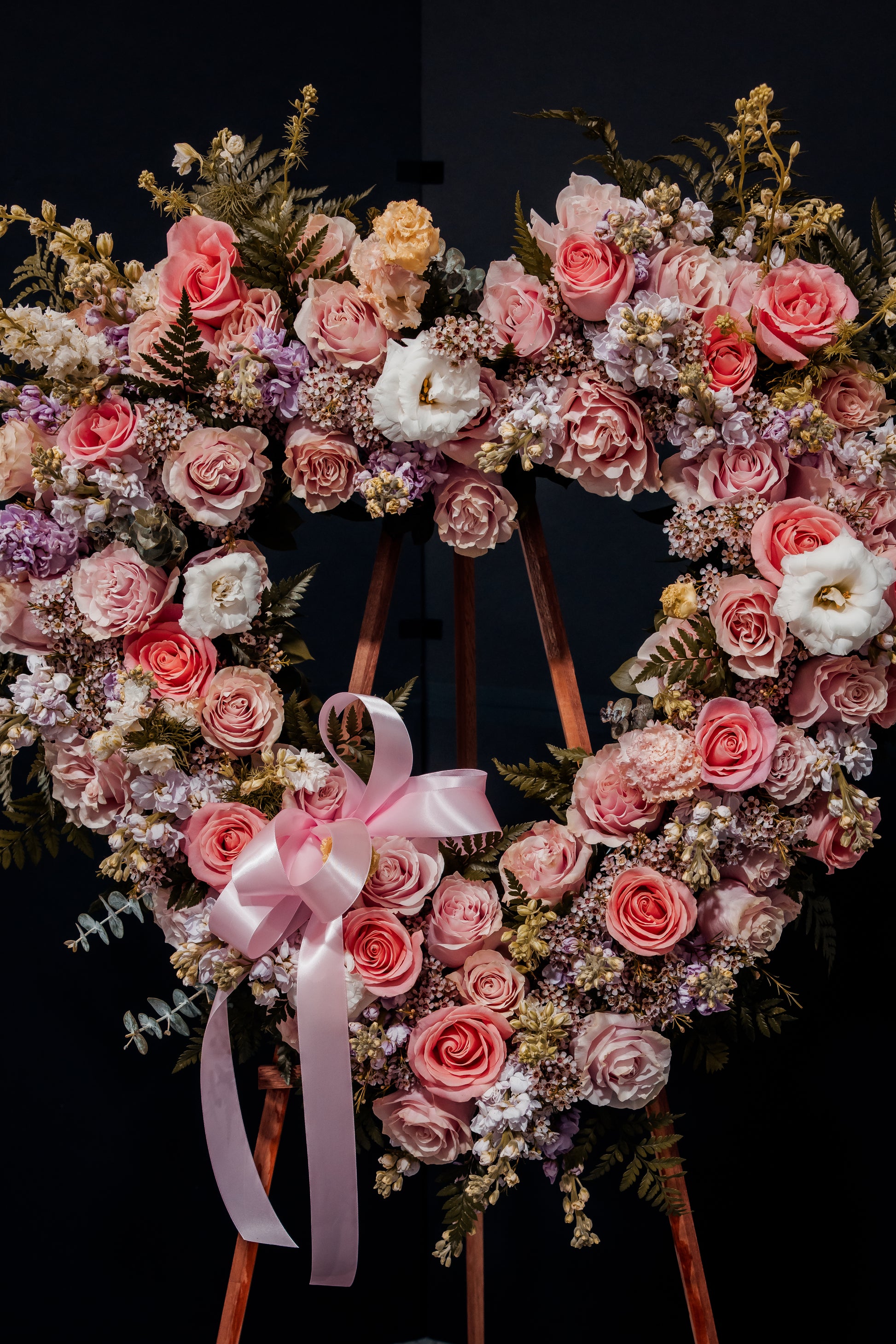 An organic heart wreath in gentle pink hues,symbolizing eternal love and sweetness.